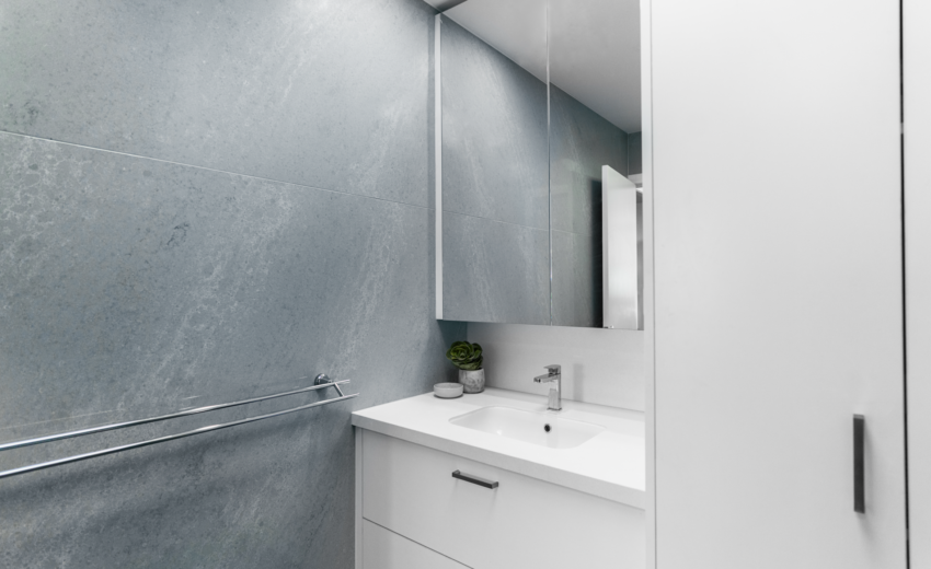 StoneCraft Kitchen & Bath | Projects We had the pleasure of transforming Lisa's modest half bath into a tranquil haven of relaxation and style. Drawing inspiration from soothing soft blue tones, we curated a calming ambiance that resonated with a sense of serenity. The carefully selected Mount Cemento stone played a pivotal role in shaping the space, enveloping the walls and the shower in an understated yet striking elegance.